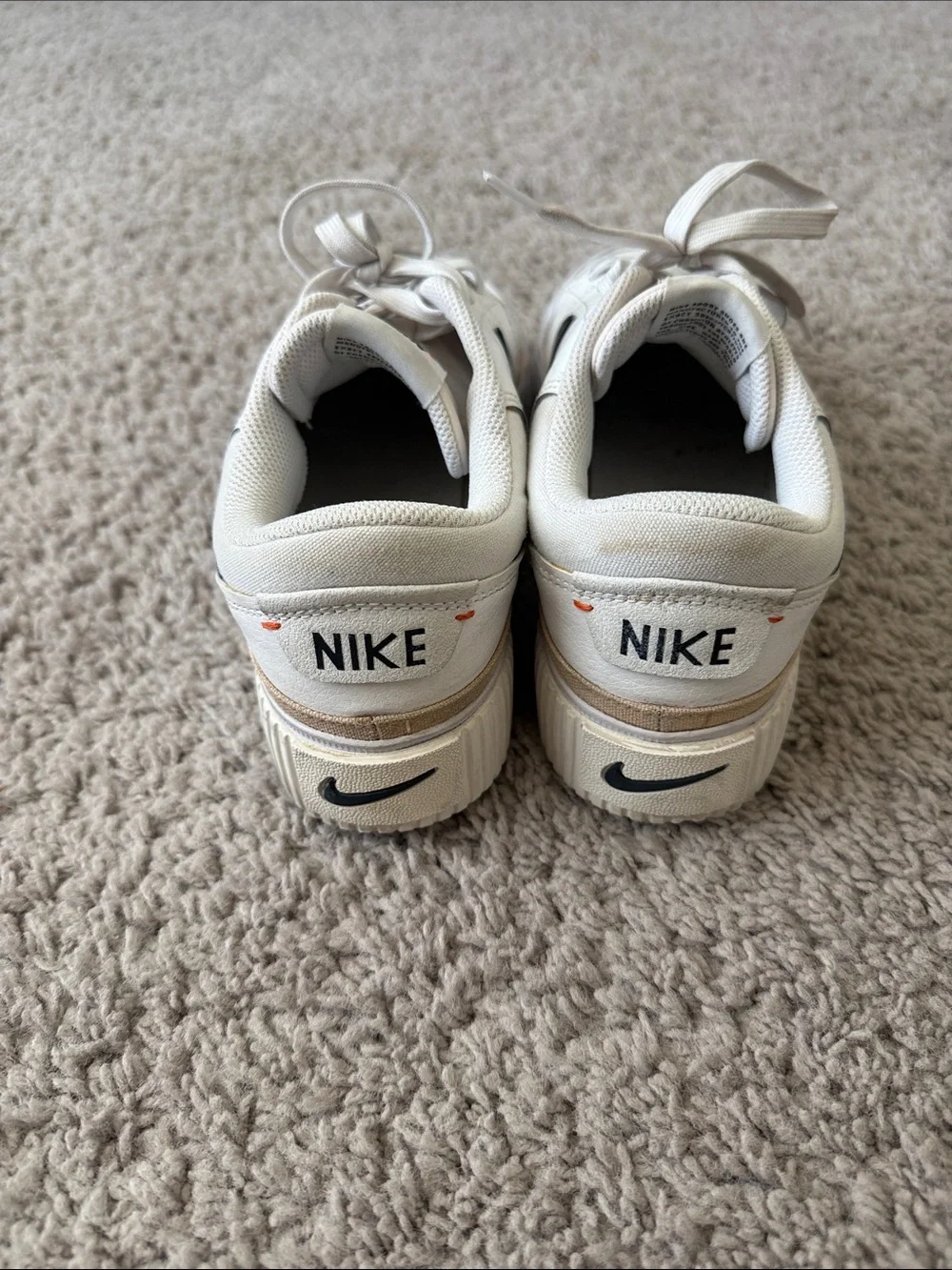 Nike White Low-Top Sneakers with Black Swoosh and Tan Trim